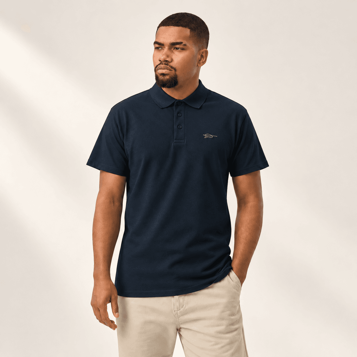 Male model wearing the fully buttoned navy signature polo, styling preview